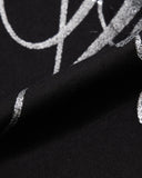 script graphic print close-up on black sweatpants
