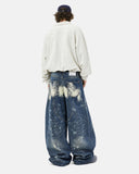 model wearing blue barrel jeans back view