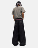 model wearing black baggy jeans back view