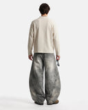 model wearing grey barrel jeans back view
