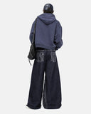 model wearing black baggy jeans back view