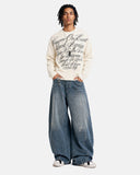 model front view wearing apricot script graphic long sleeve tee