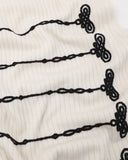close-up of chinese knot embroidery on knit fabric