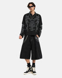 model styling black gothic layered polo shirt with shorts