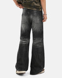 model wearing back view of black bootcut jeans 