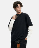 model wearing oversized layered long sleeve t shirt with cargos