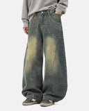 model wearing dirty blue curved seam barrel jeans front view