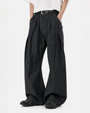 model wearing black pinstripe pleated baggy pants front view