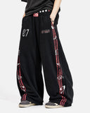 model wearing black striped barrel sweatpants front view