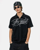 model wearing black polo t shirt with white embroidery