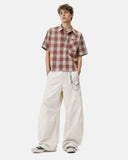 Male model wearing Cordura nylon wide leg pants in polar white with streetwear styling