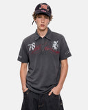 model upper body wearing washed gray graphic polo shirt