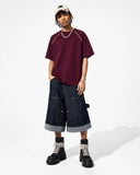 model wearing lightweight raglan t shirt with denim jorts 