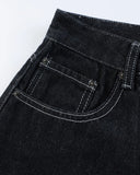 Close-up of raw denim jorts with contrast stitching detail
